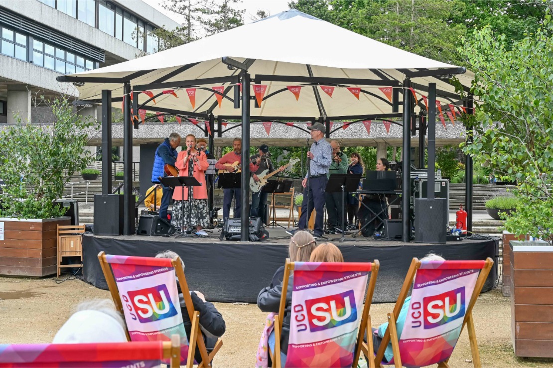 UCD staff performing on the bandstand.